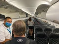 People walking down the aisle boarding an airplane