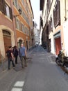 People walking down a narrow street in Rome Italy sightseeing