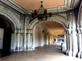 People walking down ornately carved archways in Balboa Park