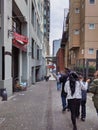 People walking down Post Alley near the gum wall in downtown historic Pike Place Market