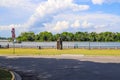 People walking down the river walk along he Savannah river with vast river water and lush green trees and grass with blue sky Royalty Free Stock Photo