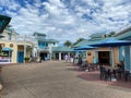 People walking through an almost empty park at Seaworld in Orlando, Florida wearing face masks and social distancing