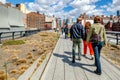 People walking, enjoying the sunny winter day at the High Line Park, NYC, rear view