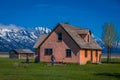 People walking at the enter of the Pink House on the John Moulton homestead on Mormon Row at Grand Teton National Park