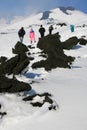 People walking on Etna Volcano covered by snow