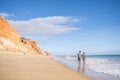 People walking on Falesia Beach with beautiful cliffs, Albufeira, Algarve, Portugal