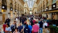 People walking in famous Italian shopping center with luxury boutiques, tourism