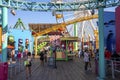 People walking by famous Route US 66 on Santa Monica Pier at Pacific park