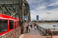 People walking the footpath of the bridge over the Rhine river in Koln Royalty Free Stock Photo