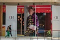 People walking in front of Carolina Herrera giant picture in The Mall at Millenia 1