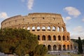 People walking in front of the Colosseum in the evening