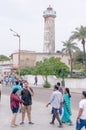 People walking in front of a lighthouse in pondicherry