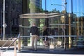 People walking through glass revolving doors