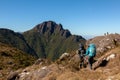 People walking with great backpacks in mountain landscape - trekking hiking mountaneering in mantiqueira range Brazil Royalty Free Stock Photo