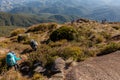 People walking with great backpacks in mountain landscape - trekking hiking mountaneering in mantiqueira range Brazil Royalty Free Stock Photo