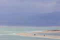 People walking on headland on stormy day at Dead Sea