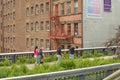 People Walking on the Highline and Viewing the Manhattan West Side Cityscape NYC