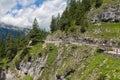 People at hiking trail through Austrian mountains to ice cave Royalty Free Stock Photo