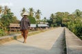 People walking on the historical bridge between Don Det and Don Khon. built by the French on the Mekong river