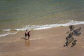 People walking on a hot day on Tenby beach Royalty Free Stock Photo