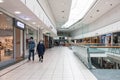 People walking through Interior of Buchanan Galleries shopping centre mall wearing fask mask protection