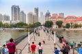 People walking the Jintang bridge over the river Haihe in Tianjin