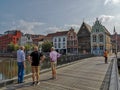 People walking on the Kraanbrug admiring the historical houses in Mechelen
