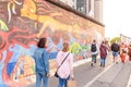 People walking and looking at Art gallery of Graffiti on Berlin Wall at East side