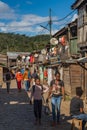 People walking at the main road at the village Andasibe, lined with shops