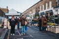 People walking between market stalls at Columbia Road Flower Market, London, UK