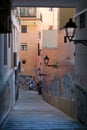 Palma, Mallorca, Spain - October 8th 2021: People walk through narrow way with graffiti in old town