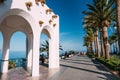 People walking near Balcon de Europa in resort town of Nerja in Royalty Free Stock Photo