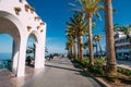 People walking near Balcon de Europa in resort town of Nerja in Royalty Free Stock Photo