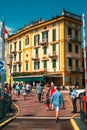 Beautiful architecture of the old lakefront hotel Olivedo in Varenna, Italy. People enjoying their walk on a sunny day.