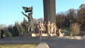 People walking near the monument of the Peoples` Friendship Arch in the fall