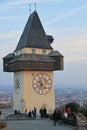 People are walking nearly city clock tower in Graz Royalty Free Stock Photo