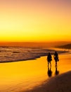 People walking ocean beach sunset Royalty Free Stock Photo