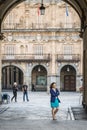 People walking in one of the entrances to the main square of the city