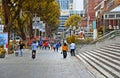 People walking in Orchard Road in Singapore modern district with modern buildings and architecture in background.