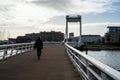 People walking over Forton Lake Bridge or the Millennium Bridge in Gosport UK