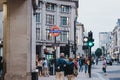 People walking on Oxford street near entrance to Oxford Circus tube station, London, UK