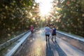 People walking in park with morning sun shine lens flare