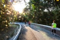 People walking in park with morning sun shine lens flare