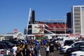 People walking through parking lot to arena