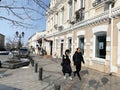 Vladivostok, Russia, March,03,2020. People walking past Aliis Coffee building on Admirala Fokina Street in spring Royalty Free Stock Photo