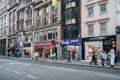 People walking past American Candy Stores on New Oxford Street, London, UK