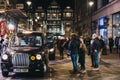 People walking past black cabs parked on Argyll Street, London, UK Royalty Free Stock Photo