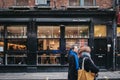 People walking past Bone Daddies restaurant in Covent Garden, London, UK