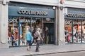 People walking past Cool Brittania souvenirs and gift shop in London, UK