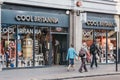 People walking past Cool Brittania souvenirs and gift shop in London, UK